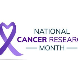 Text on a white background reading "National Cancer Research Month" with a purple ribbon in a heart-shape.